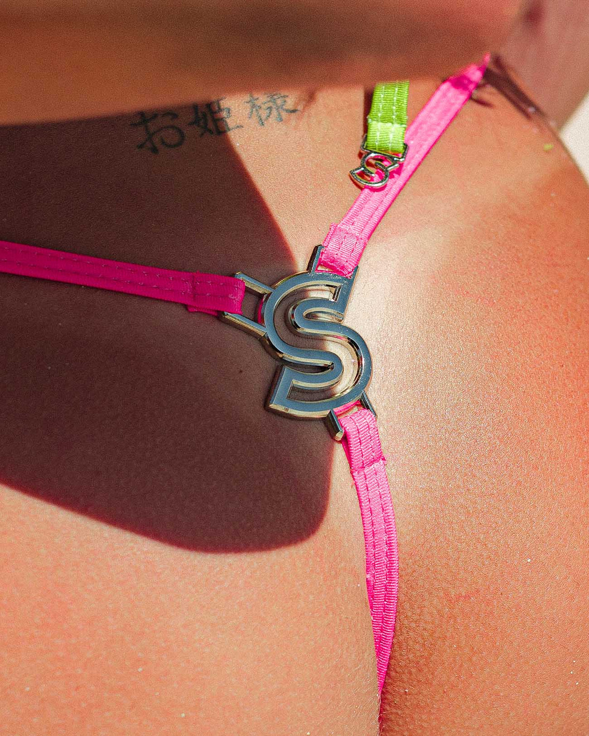Premium Fizzy - (Backlink Thong) close-up with colorful straps and charm design.