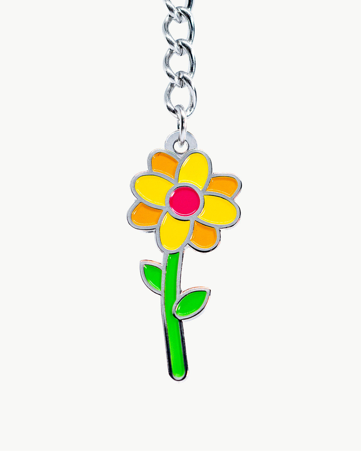 Vibrant orange flower charm with green stem, perfect for nature lovers and floral enthusiasts.
