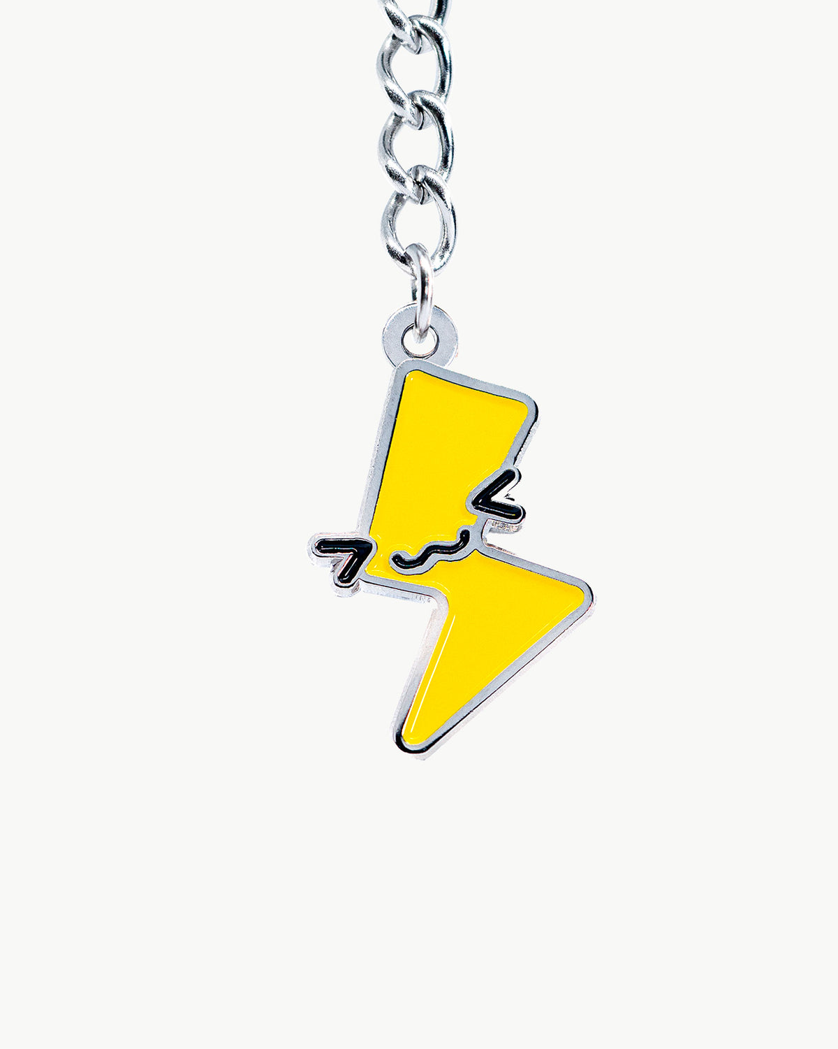 Kawaii lightning bolt charm featuring a cute face, vibrant yellow and black details, perfect for accessories and collectors.