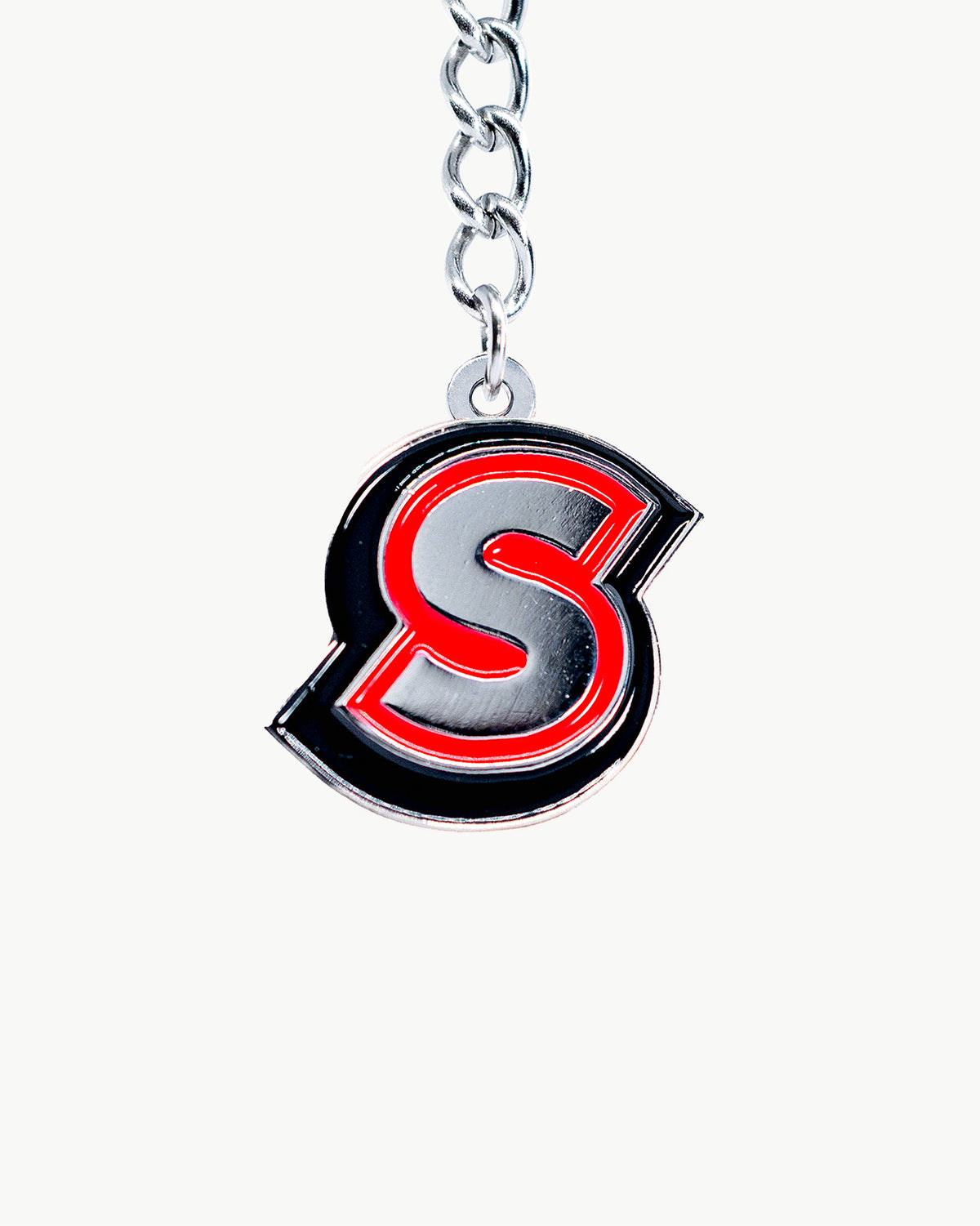 Classic S charm in signature black and red, perfect for adding elegance to accessories or collections.