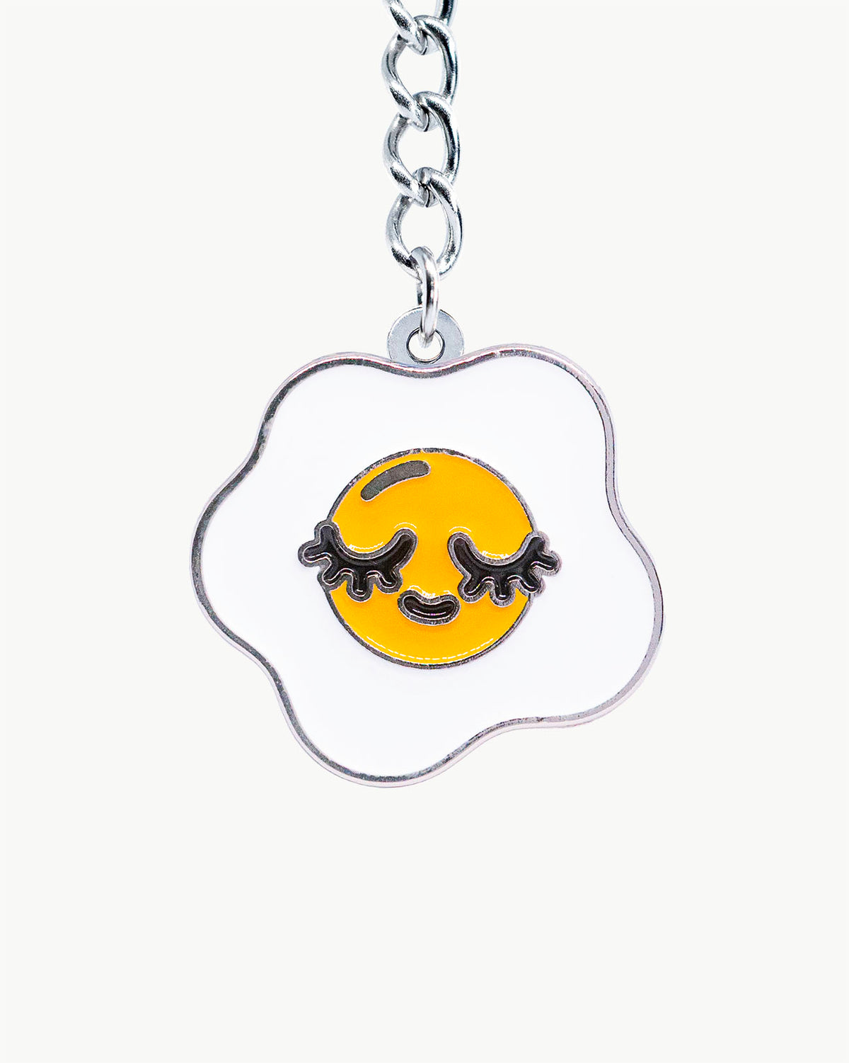 Bikini Charm - Yolk Charm high-quality enamel accessory with smiling fried egg design.