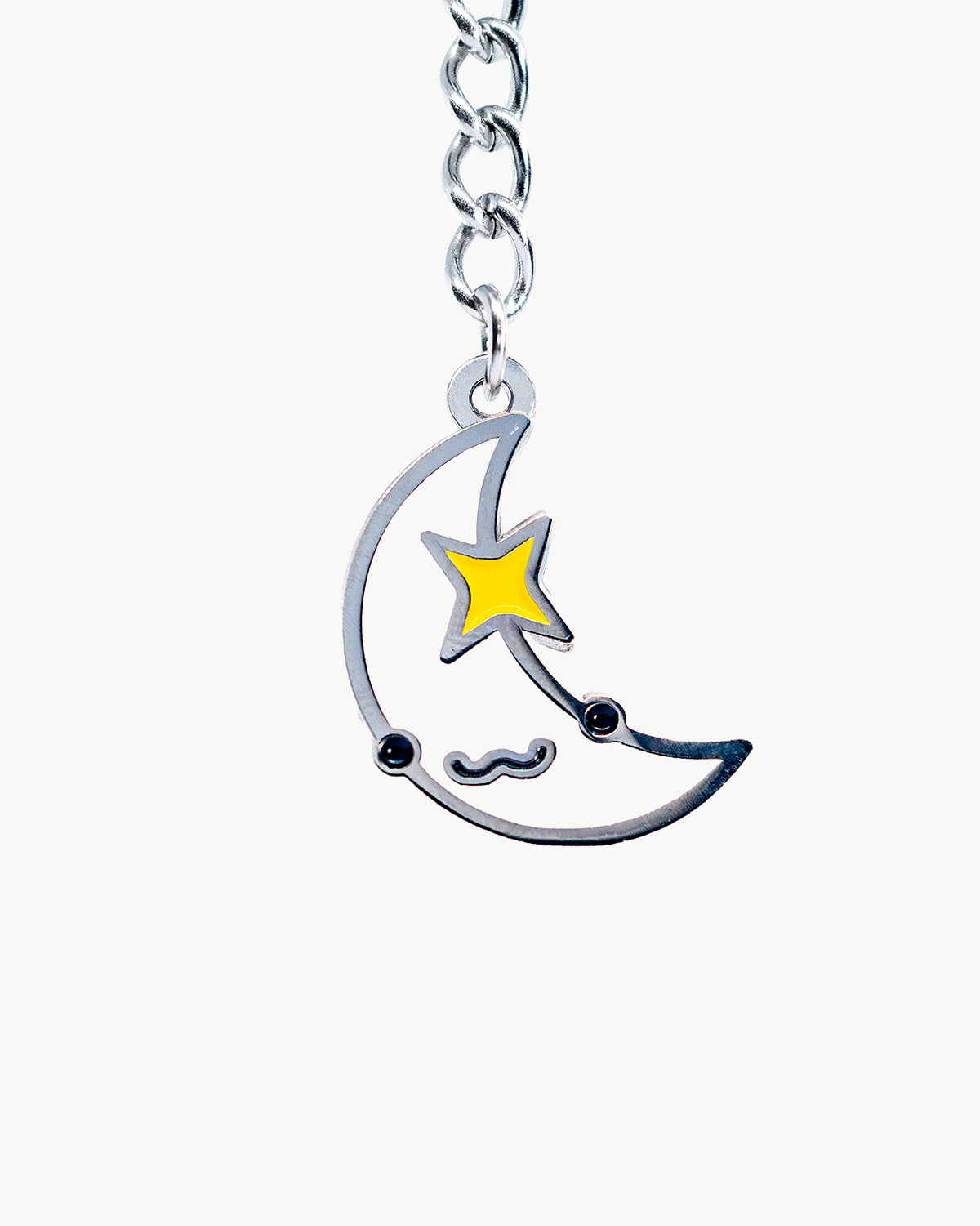 Kawaii moon charm with cute face and star, perfect for accessories and collections. Vibrant colors and playful design.