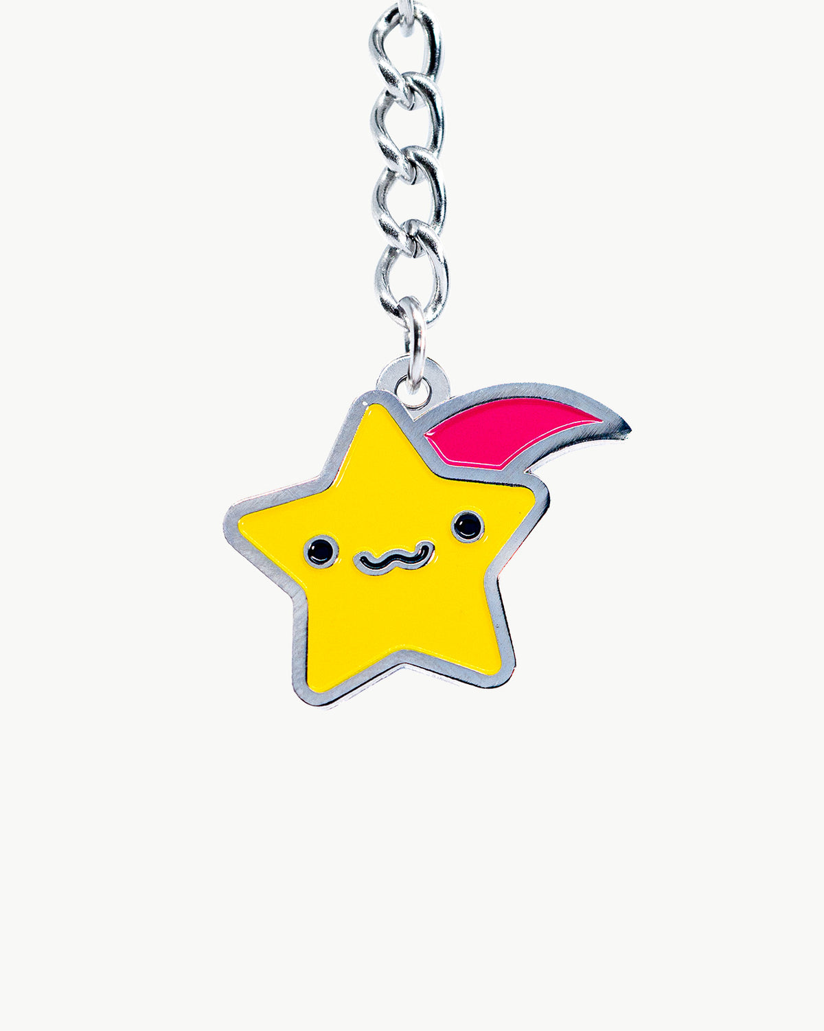 Kawaii shooting star charm with a cute face, vibrant yellow and pink colors, perfect for accessories.