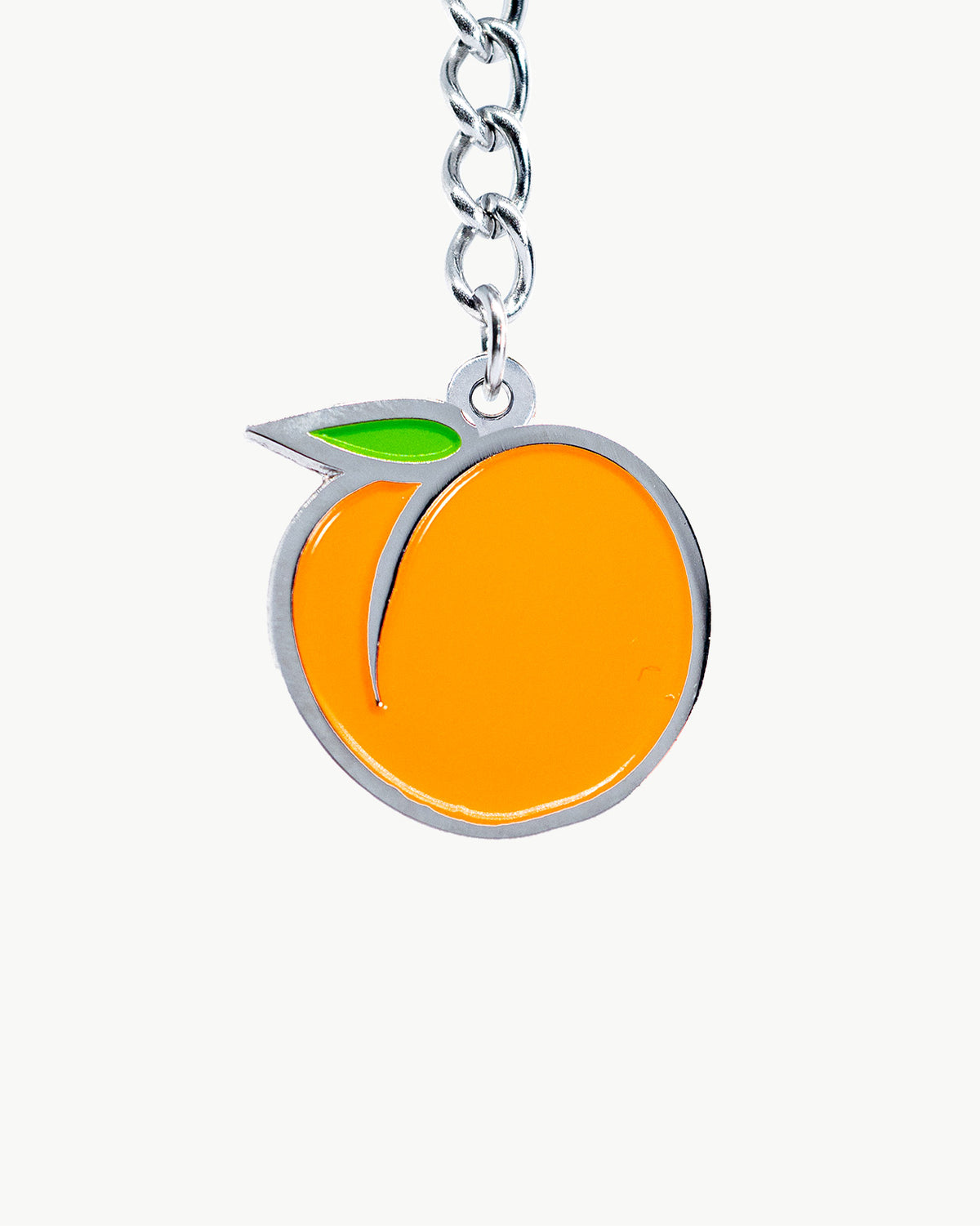 Juicy peach bikini charm in vibrant orange and green, perfect summer accessory for swimsuits.