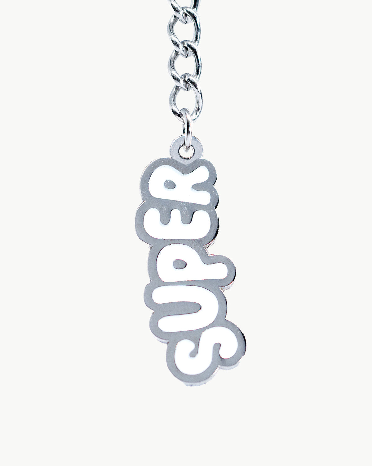 Silver 'Super' charm on a chain, perfect for adding a playful touch to accessories or jewelry collections.