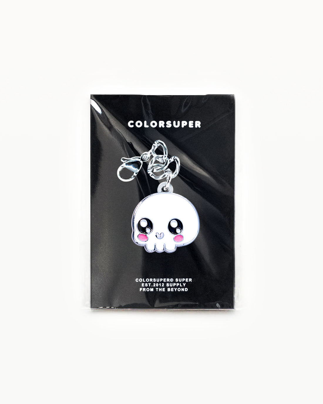 Bikini Charm - Skull Charm displayed in packaging, featuring a cute kawaii skull design with a cheerful face. - Alternate view