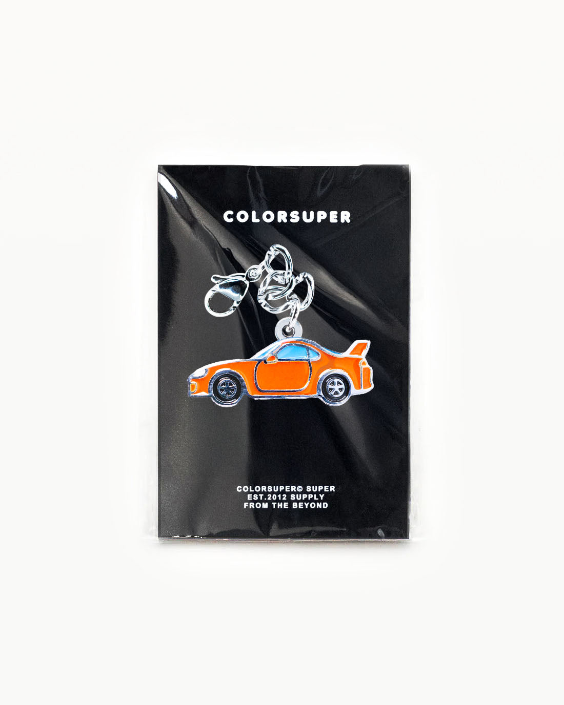 Bikini Charm - Supera Charm enamel accessory featuring a sleek orange sports car design on a black background. - Alternate view