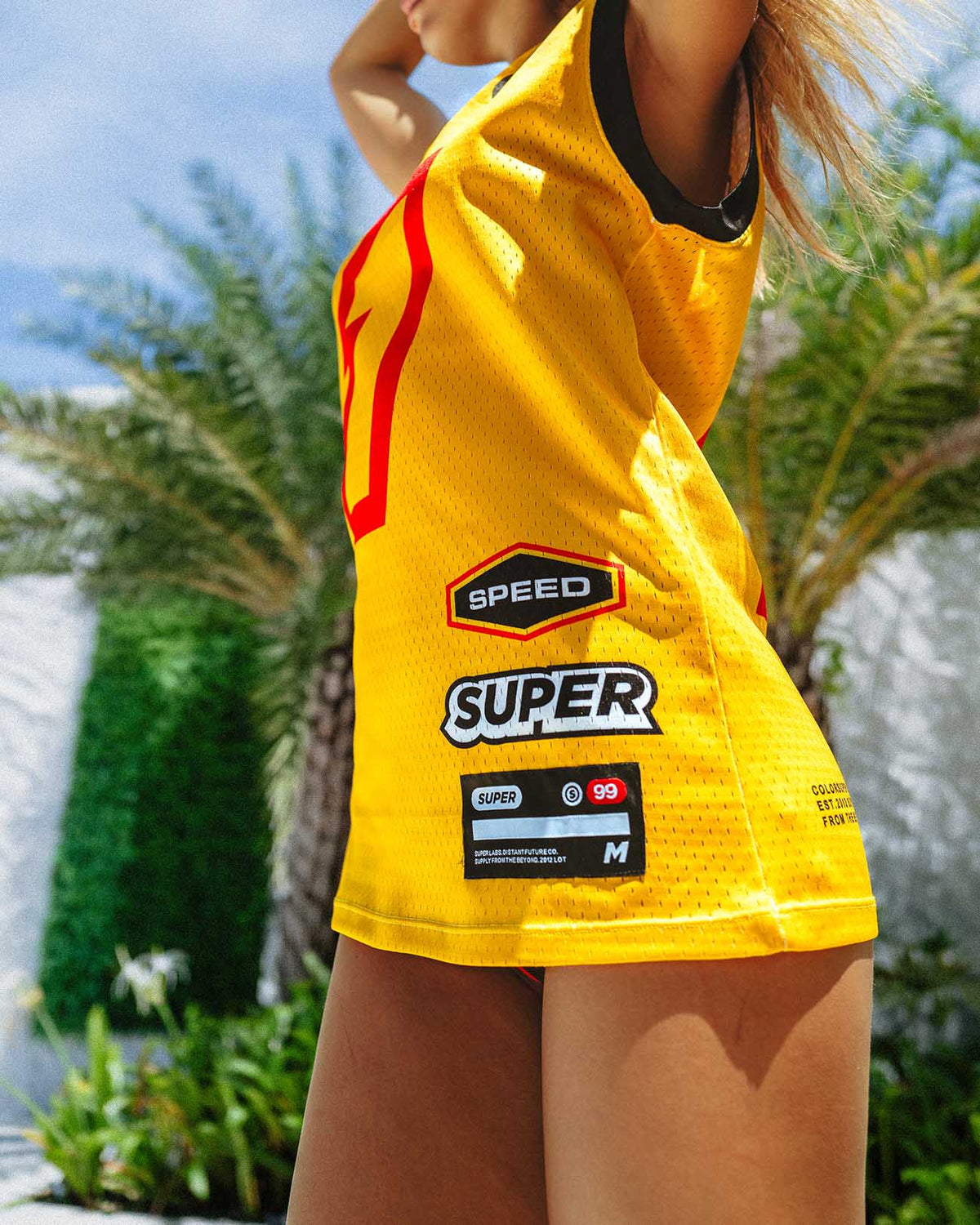 Oversized yellow jersey featuring sporty sponsor graphics, perfect for summer outings and casual hangouts.